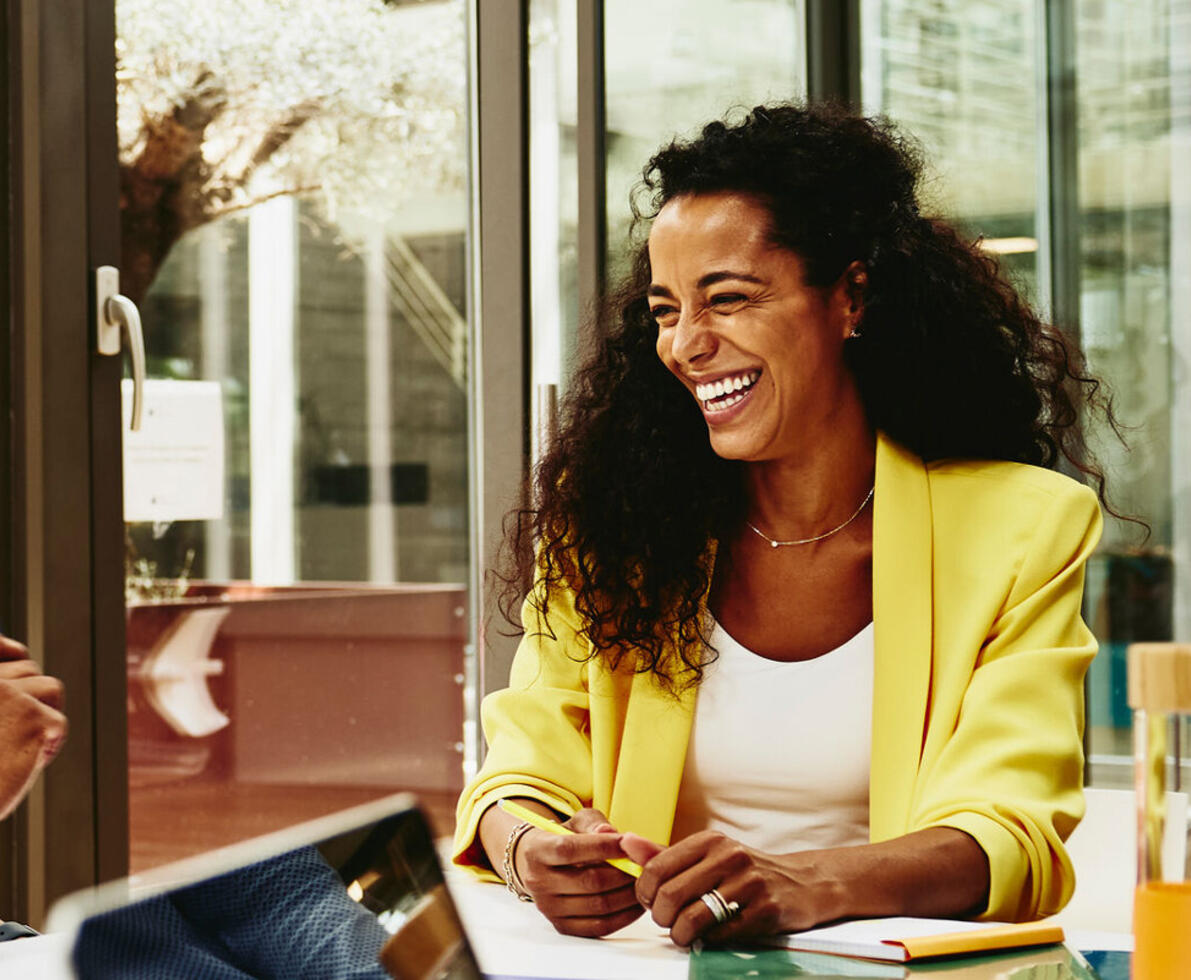 Randstad Professional male and female talking and having a laugh at the office