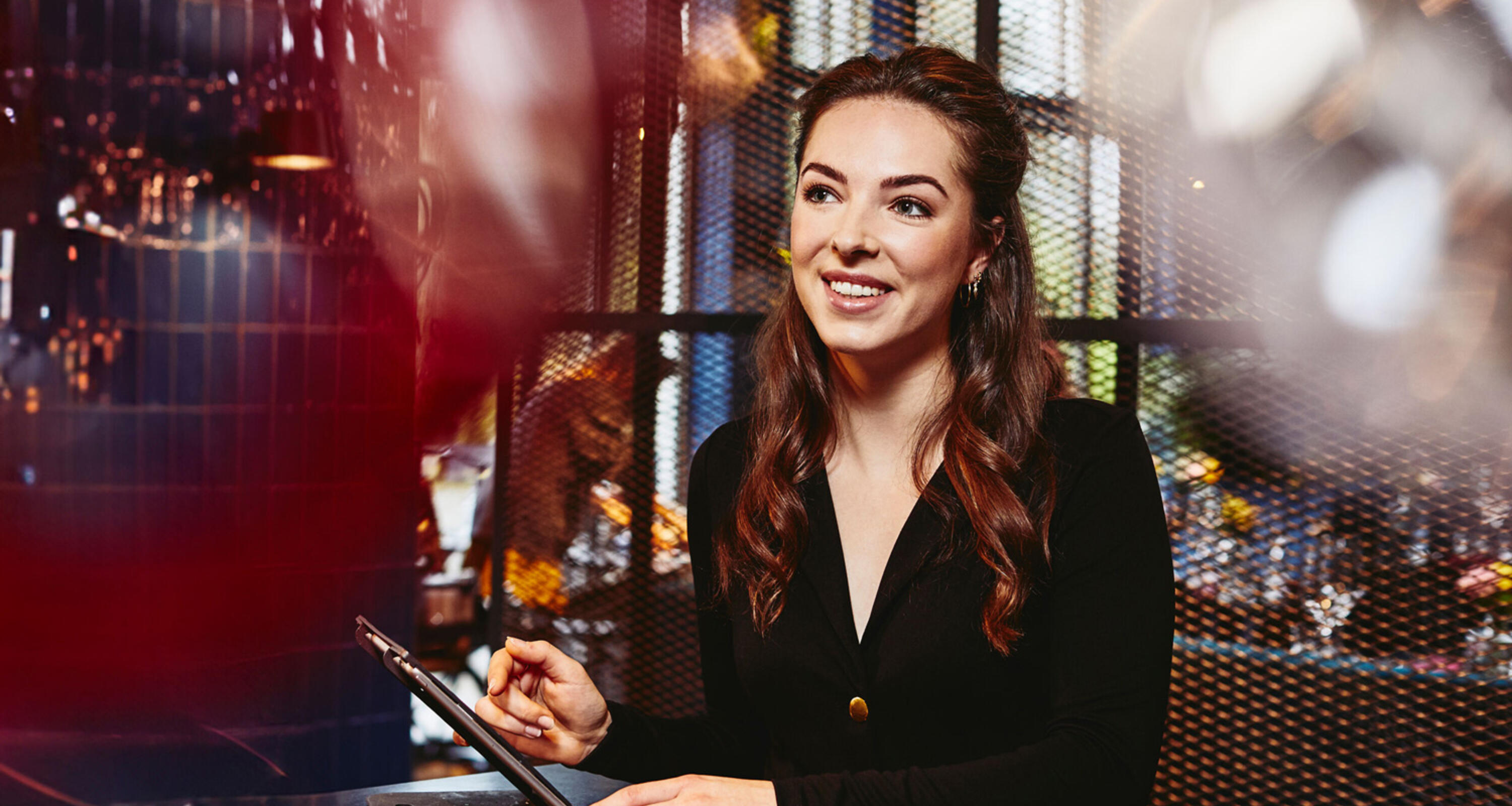 Randstad Operational Handel Smiling female looking away, behind the reception desk